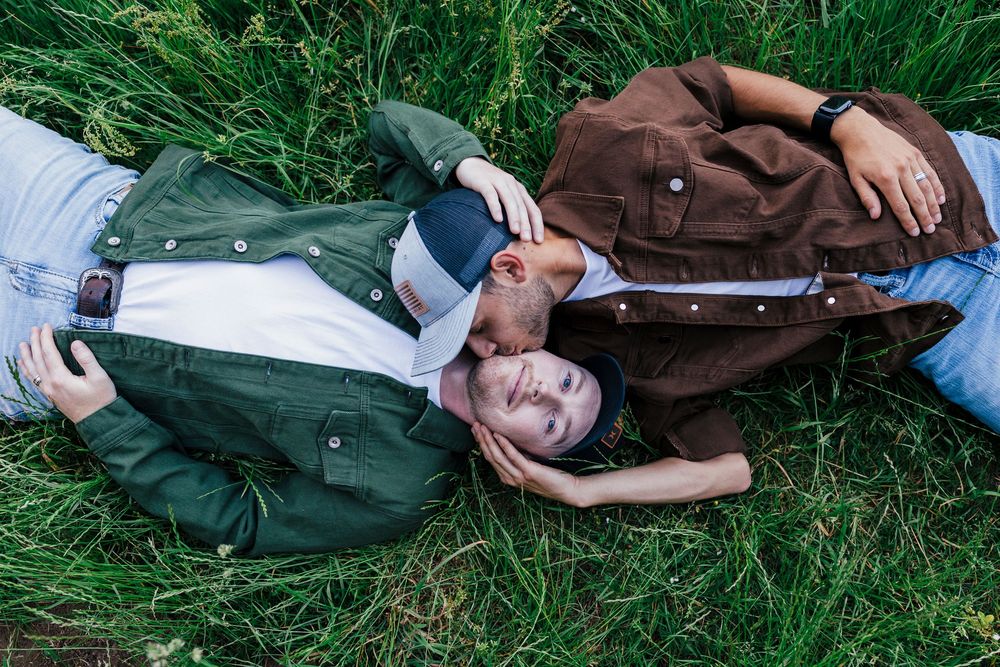 People lying in grass enjoying a warm summer day, arranged in a symmetrical aerial composition.