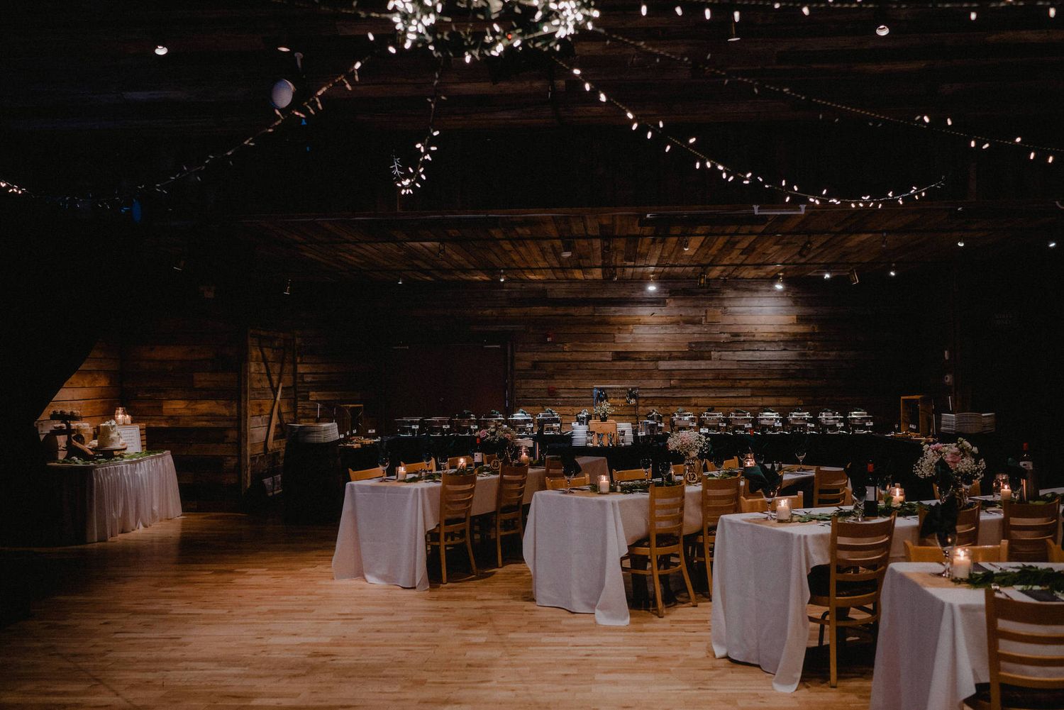 Charming wedding reception at Cornerstone Theatre, Canmore, featuring wooden decor, candlelit tables, and Ideal ambiance for the reception.