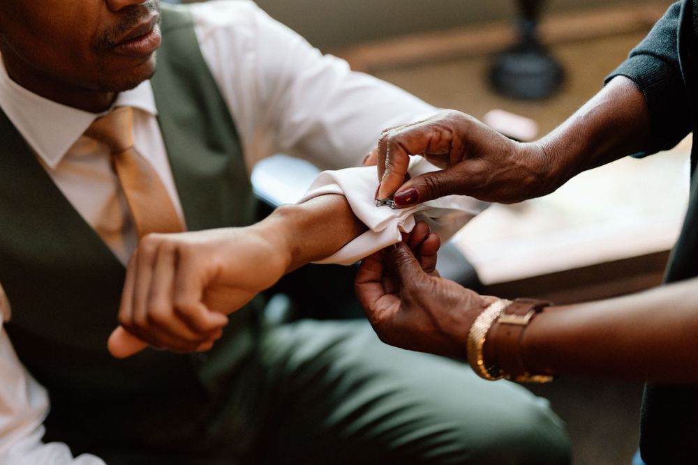 Close up view of hands exchanging a business card during a professional meeting.