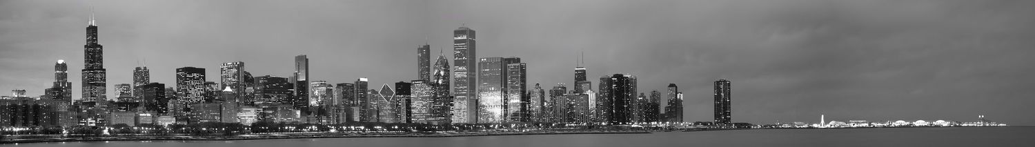 Black and white panoramic skyline of Chicago's downtown waterfront.