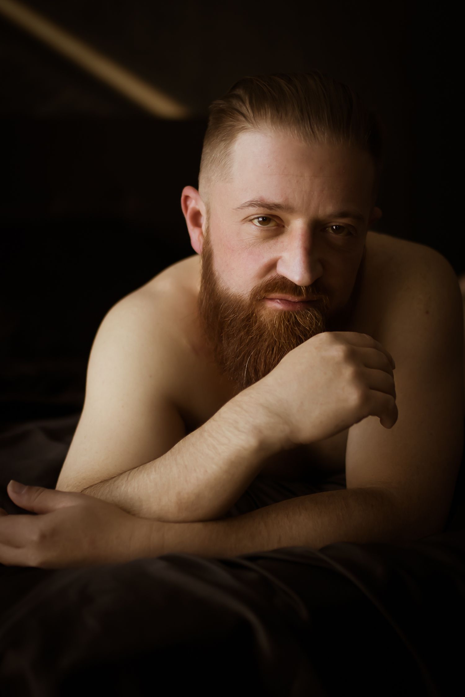 Male boudoir session in Fort Worth, emphasizing empowerment and confidence for men in a comfortable home studio.