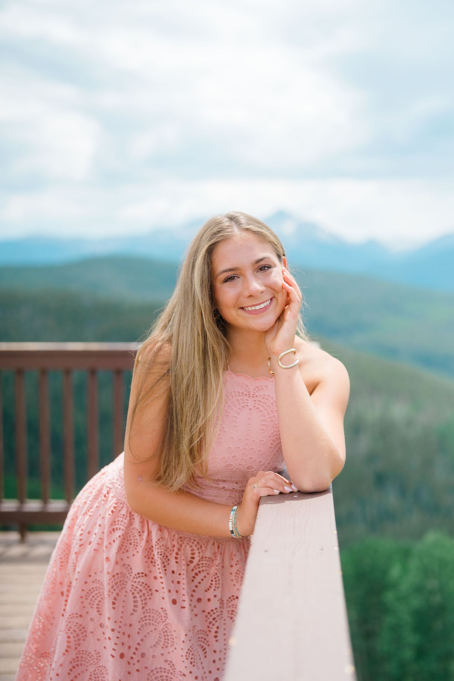 girl leaning on railing up at vail mountain