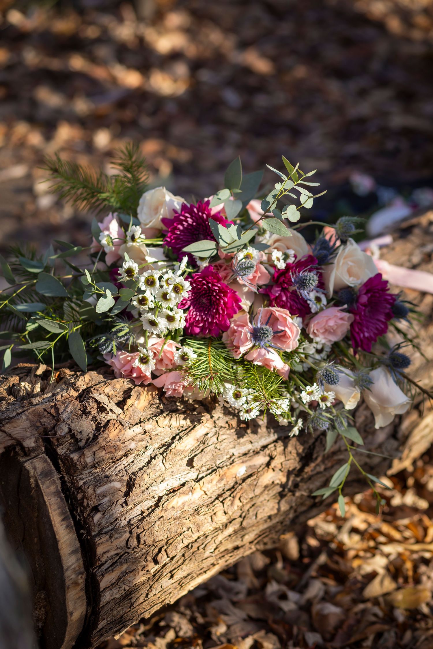 Dark pink and light pink bouquet on log