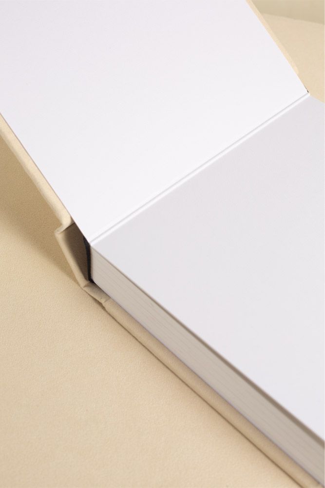 Close-up progression of a white minimalist book cover edge showing texture and paper thickness from multiple angles.