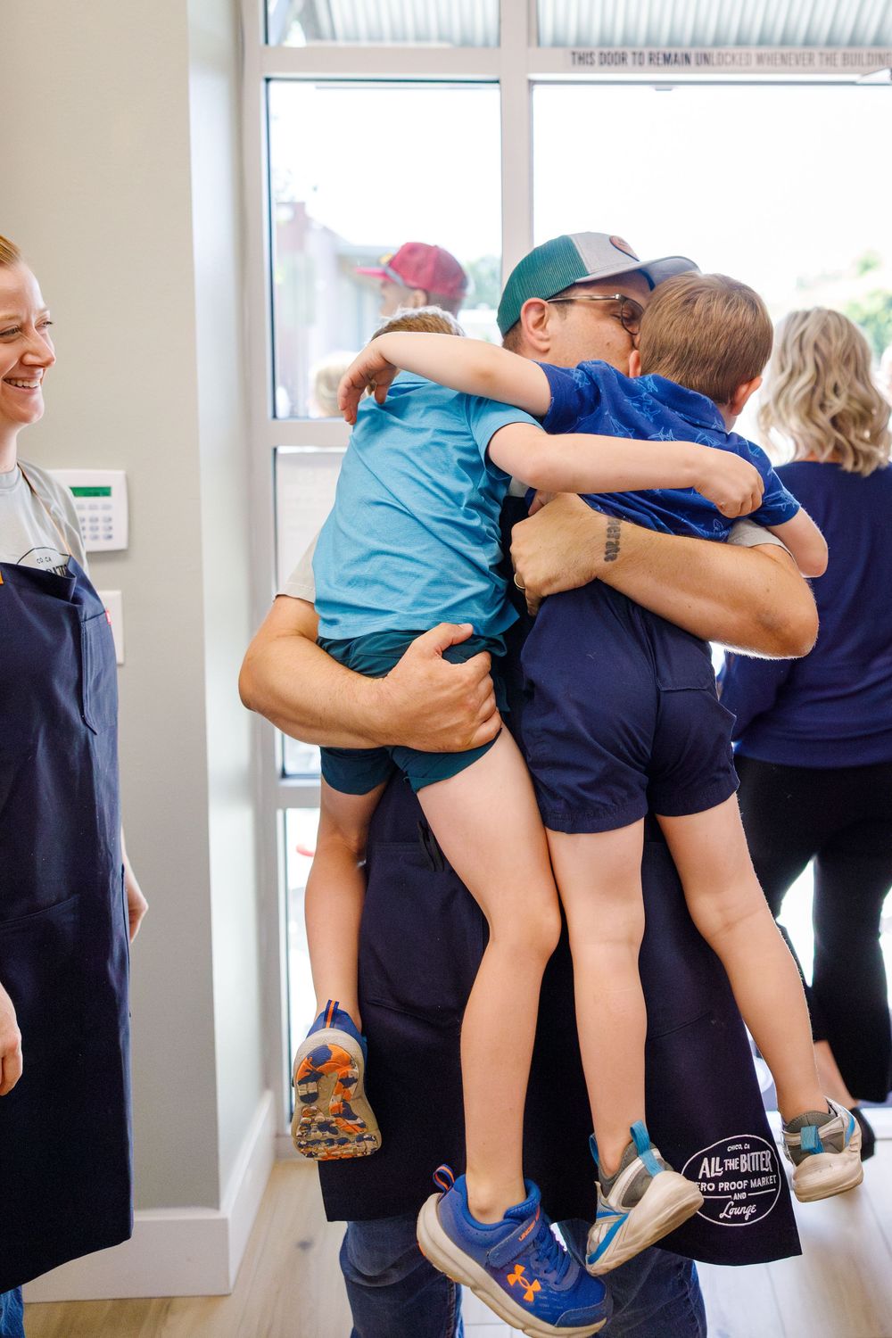 Series of images showing a child being carried inside what appears to be a childcare or school environment.