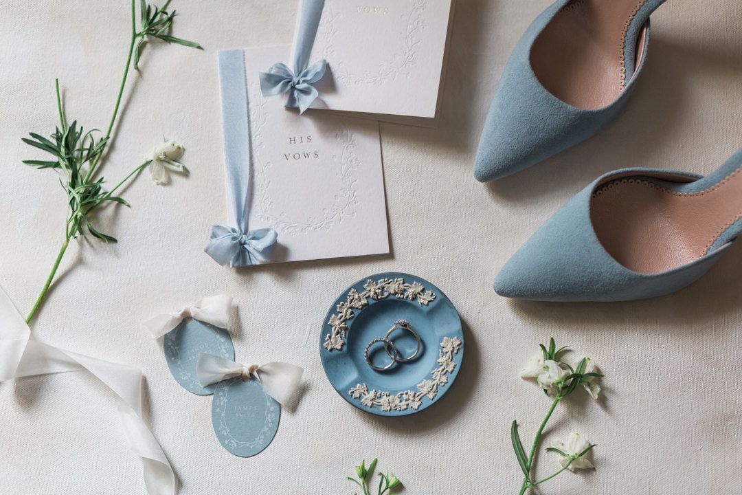 Elegant flatlay of exquisite blue and white wedding details featuring floral elements and delicate stationery at Cornwell Manor Hayley Eliza