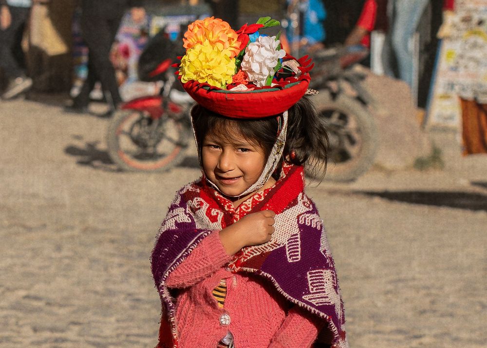 Traditionally dressed group in Peru engaged in colorful cultural celebrations and dancing in a historic town square.