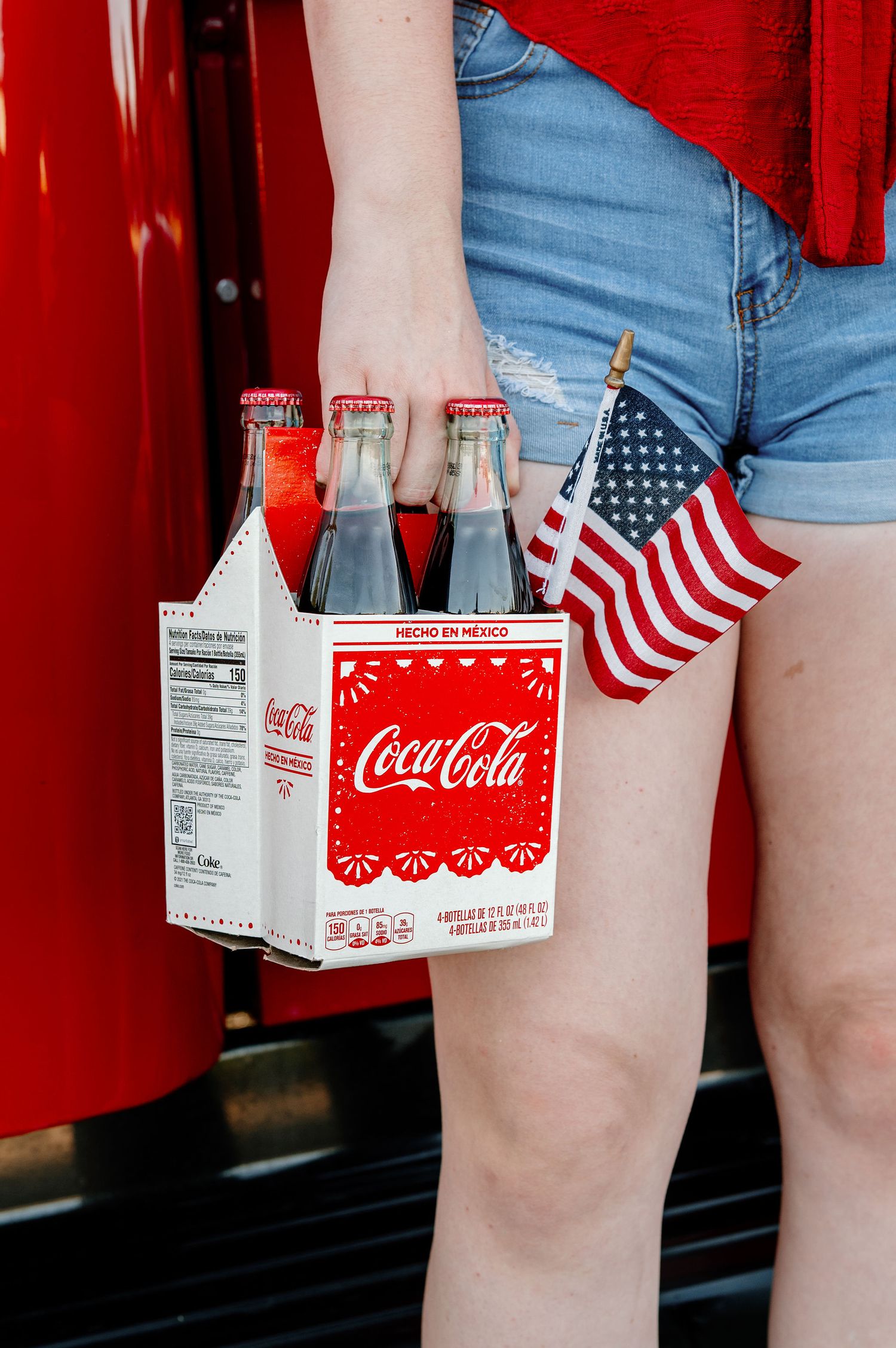 Classic Americana senior pictures with 4th of July colors, American flags, and vintage Coke bottles