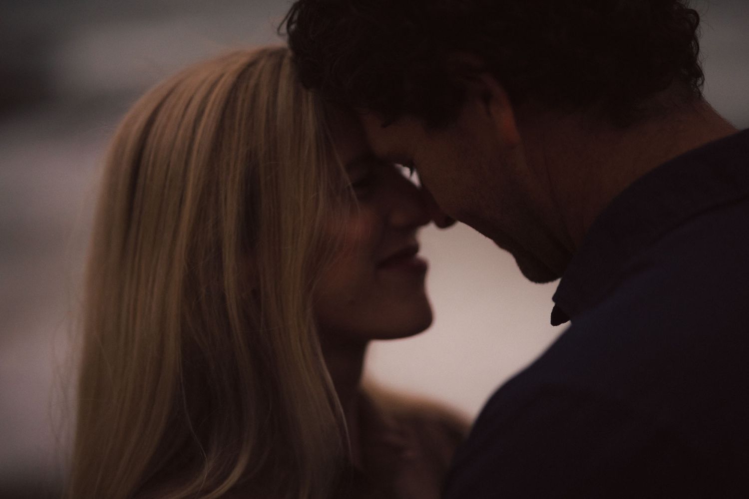 A montage of dark silhouetted couples engaging in intimate moments with soft lighting and romantic ambiance.