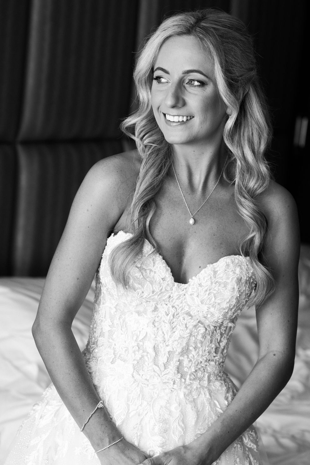 A sequence of monochrome photos showing a bride in a strapless lace wedding gown sitting and smiling.