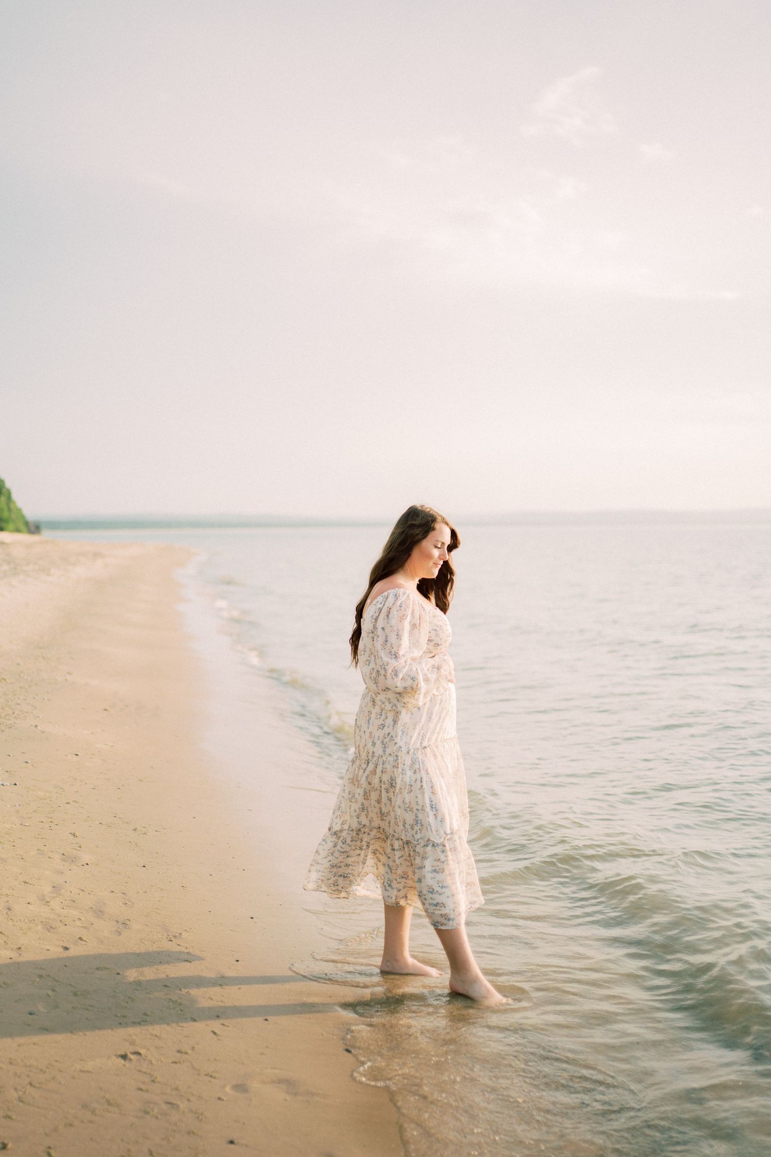 Outdoor portrait in soft sunlight with white button-up shirt against blurred natural backdrop of tall grasses.