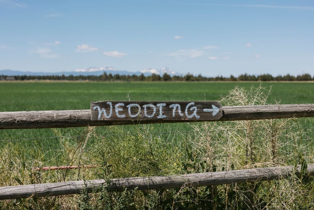 Series of panoramic views of a grassy field with mountains in the background and rustic wooden fence posts.