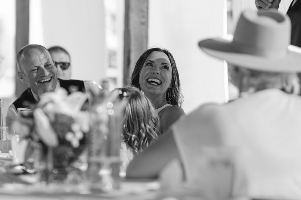 Wedding guests dancing and mingling at a fun monochrome black and white reception celebration.