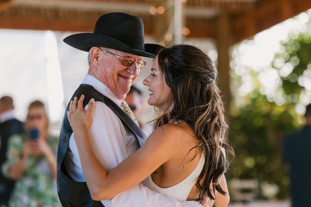 Two dancers sharing an intimate moment during a celebration at an indoor venue.