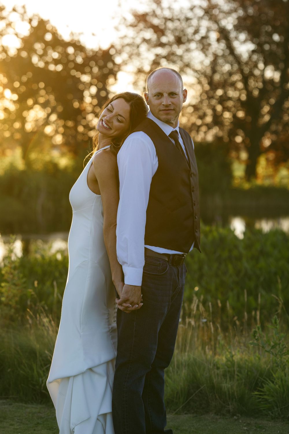 A romantic golden hour portrait session in a grassy field at sunset.