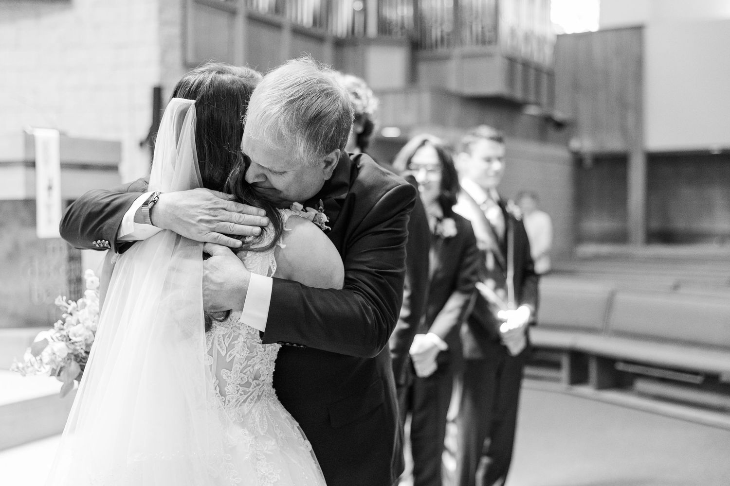 A series of black and white photos showing intimate moments of embraces at what appears to be a wedding ceremony.