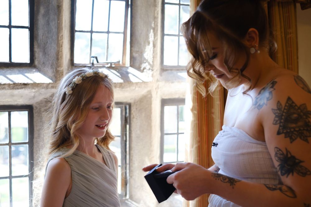 Bride helping her flower girl with her necklace at Holdsworth House, Halifax