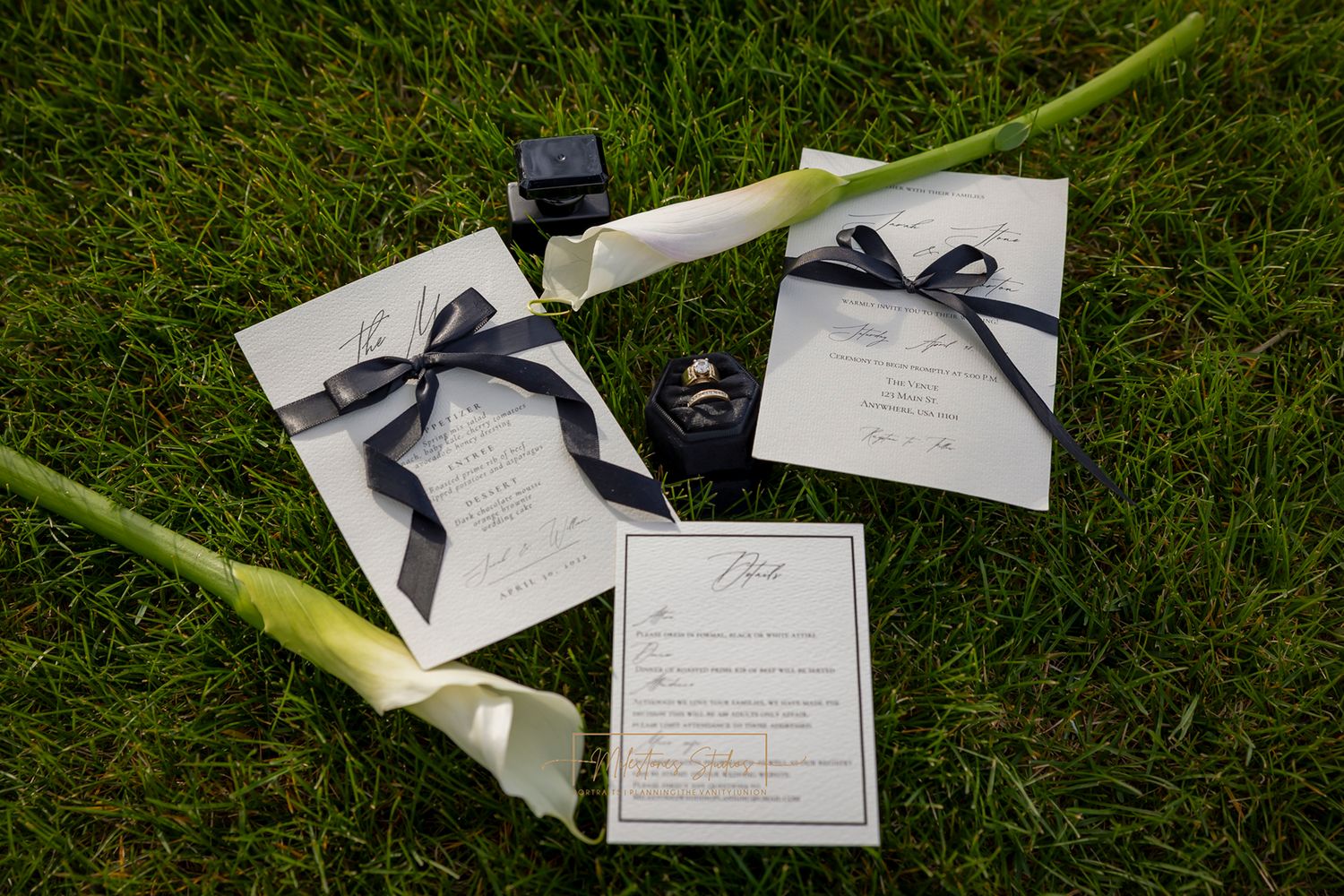 Formal black and white lay flat with Calla Lilies