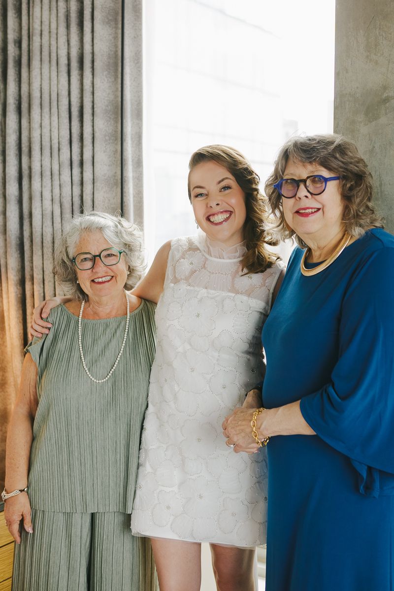 Bride sharing a warm embrace with mom and mother-in-law before walking down the aisle at Town & Village Synagogue in NYC.