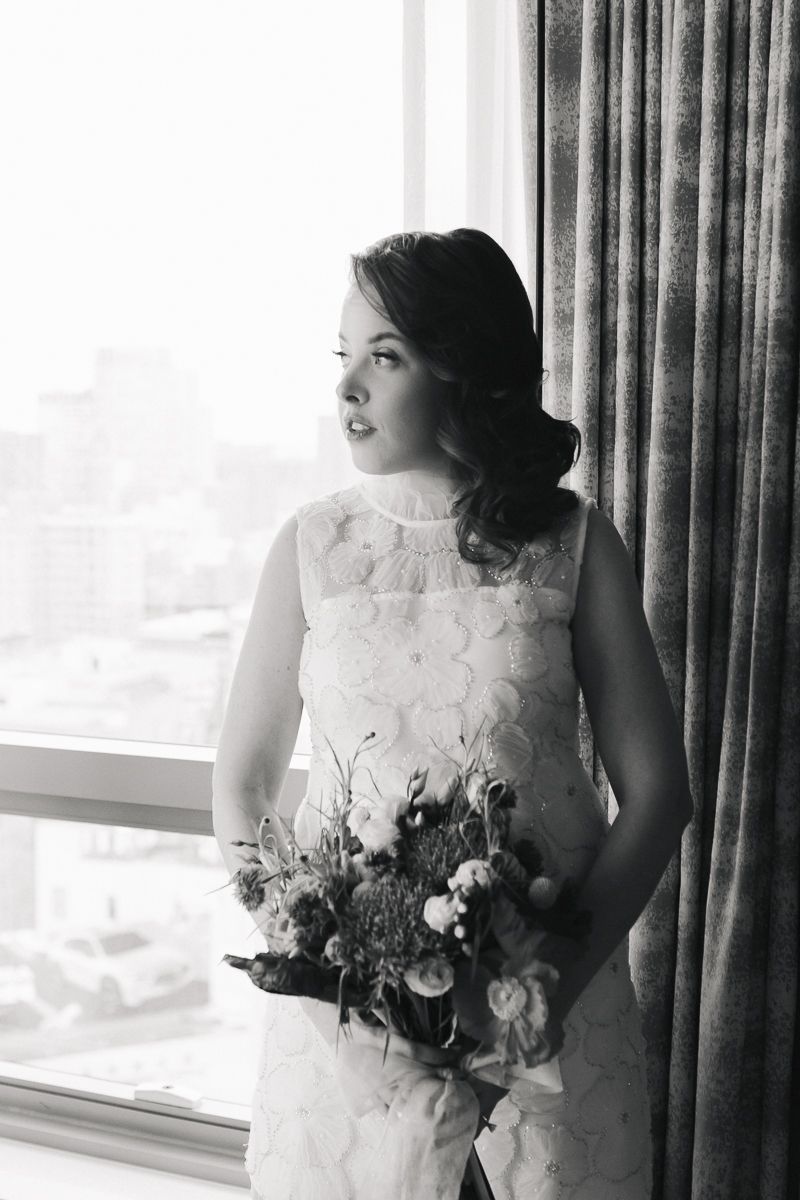 Bride holding her bouquet with a soft smile, captured beautifully by Paula Brearley in NYC.