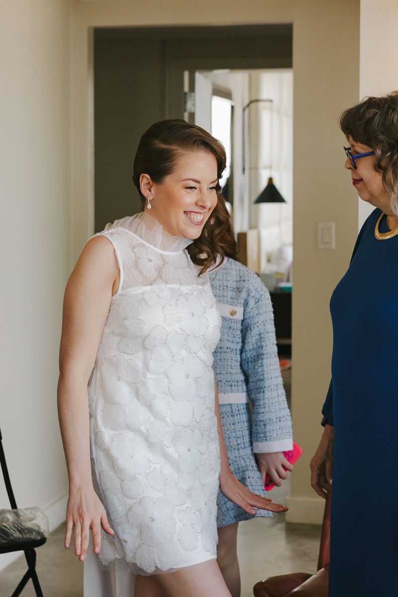 Candid moment of the bride getting ready, surrounded by family, beautifully documented in NYC by Paula Brearley.