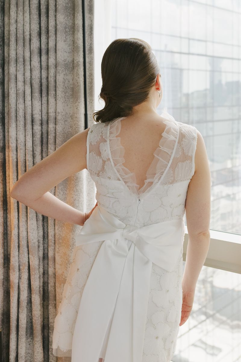 Close-up of delicate bow detail on the bride’s dress, highlighting timeless elegance at this NYC intimate wedding.