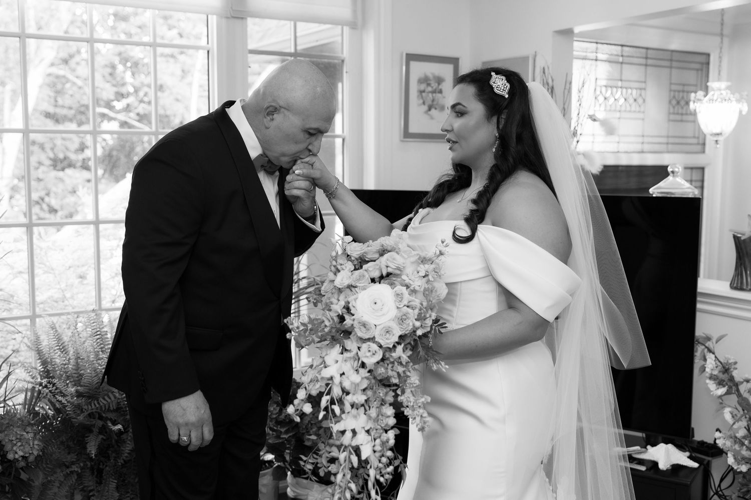 A touching black and white moment shared during wedding preparations.