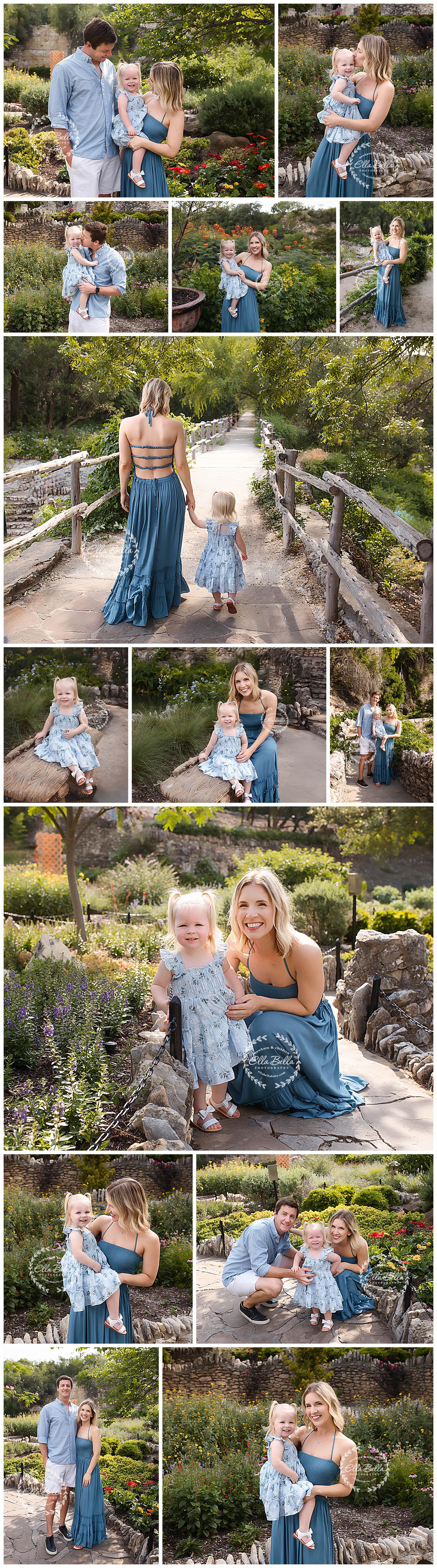 Family in coordinating blue outfits poses together in a lush garden setting with stone pathways and colorful flowers.