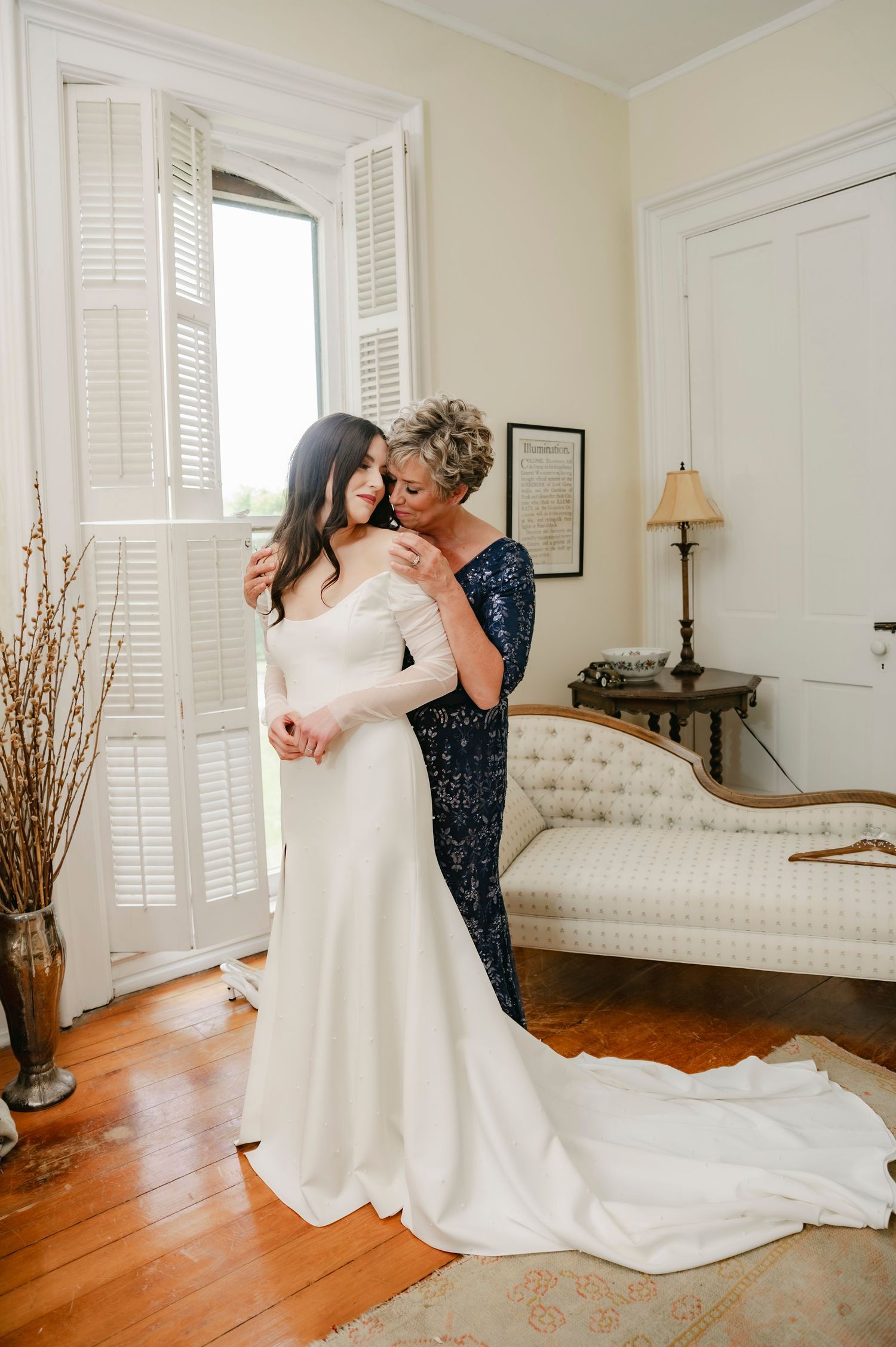 Mother of the bride helping her daughter into her wedding gown at Village View Farm, a Lexington KY spring wedding