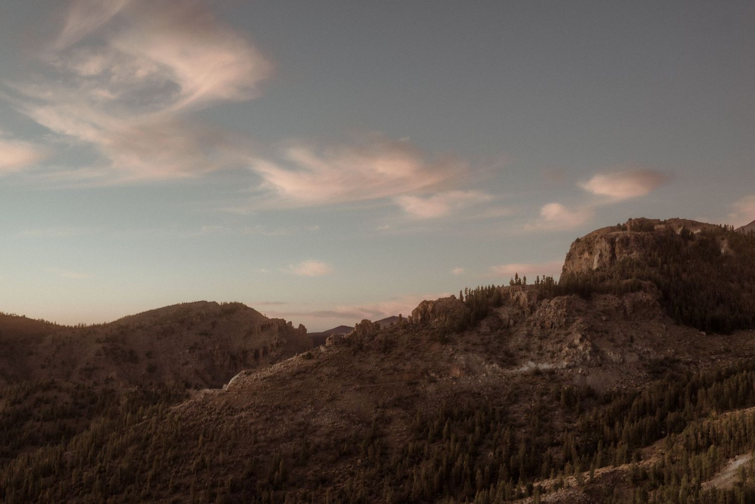 Rugged mountain peaks glow under pastel sunset sky in wilderness landscape. Tenerife Wedding Photographer at Teide.