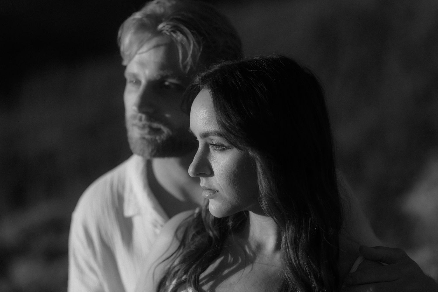 A moody black and white portrait capturing a couple's connection in natural light. Tenerife Wedding Photographer at Teide.