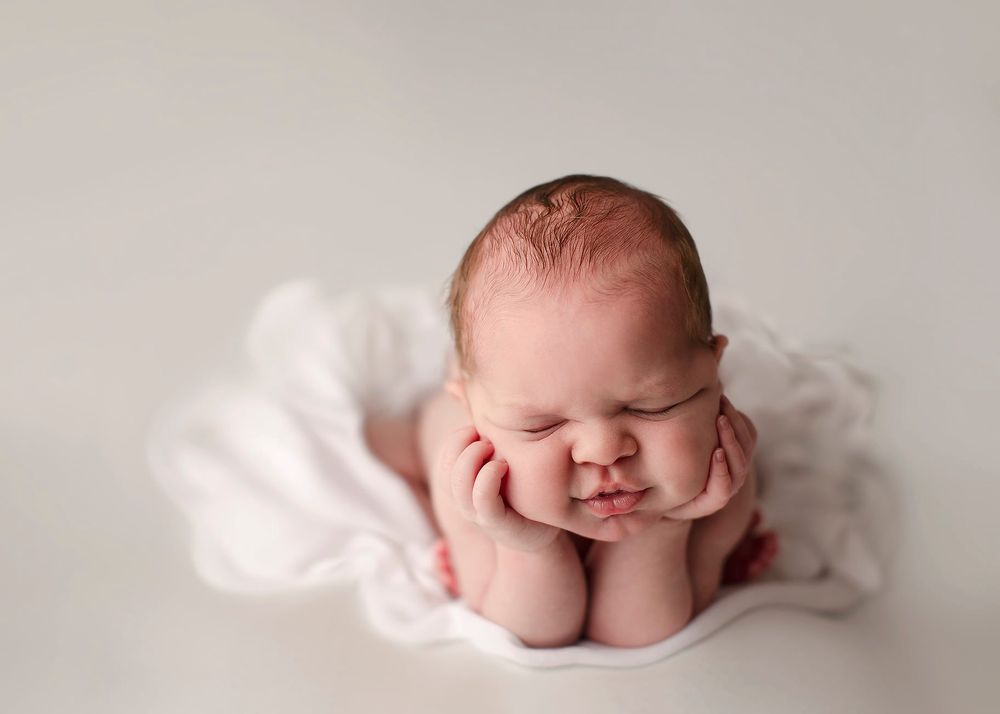 Newborn baby girl froggy pose from Elizabeth Lang Photography in Surrey.