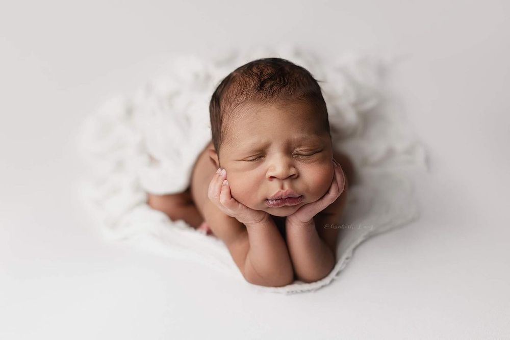 Newborn baby girl froggy pose from Elizabeth Lang Photography in Surrey.