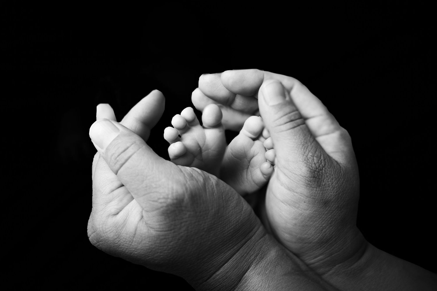 black and white hands with newborn feet.Carlsbad NM. Roswell NM. Artesia NM. Newborn and maternity photographer. baby pictures. Carlsbad nm