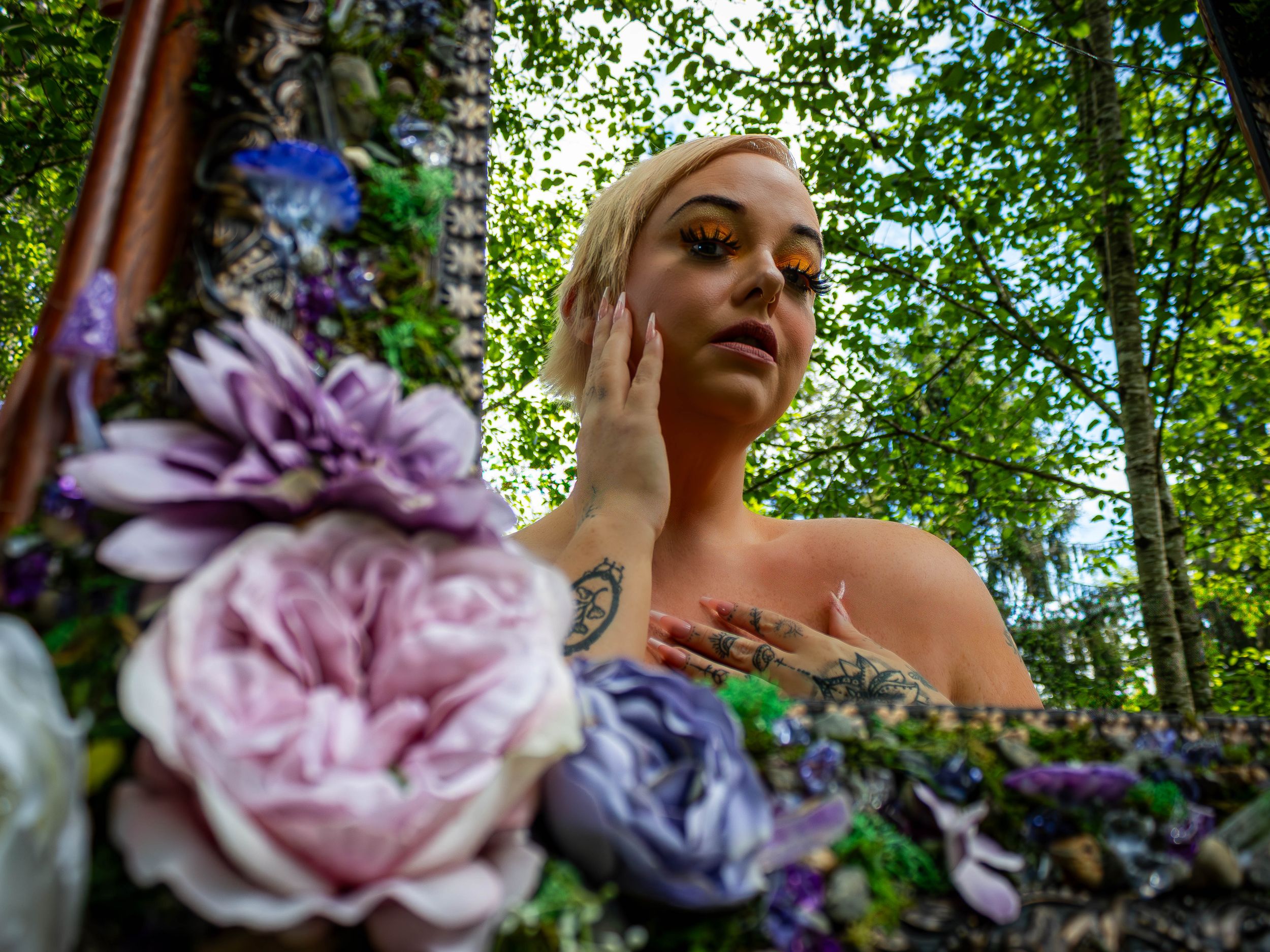 A dreamy garden scene with soft pink roses and purple flowers framing the ethereal composition in natural lighting.
