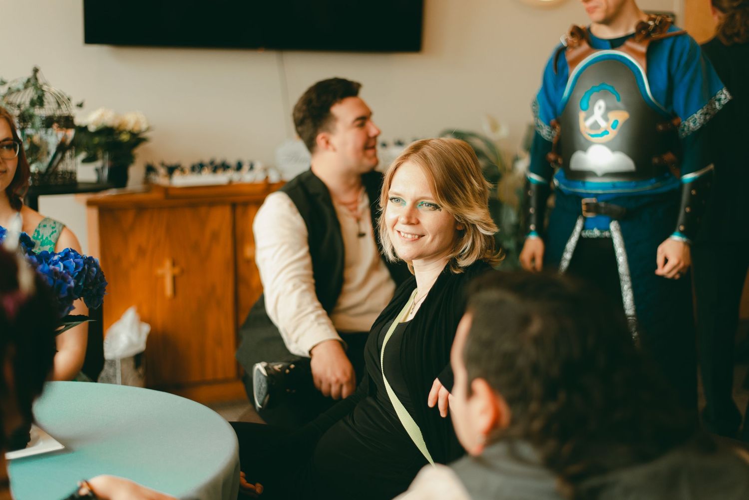 Family and friends laugh and talk together at lunchtime wedding reception