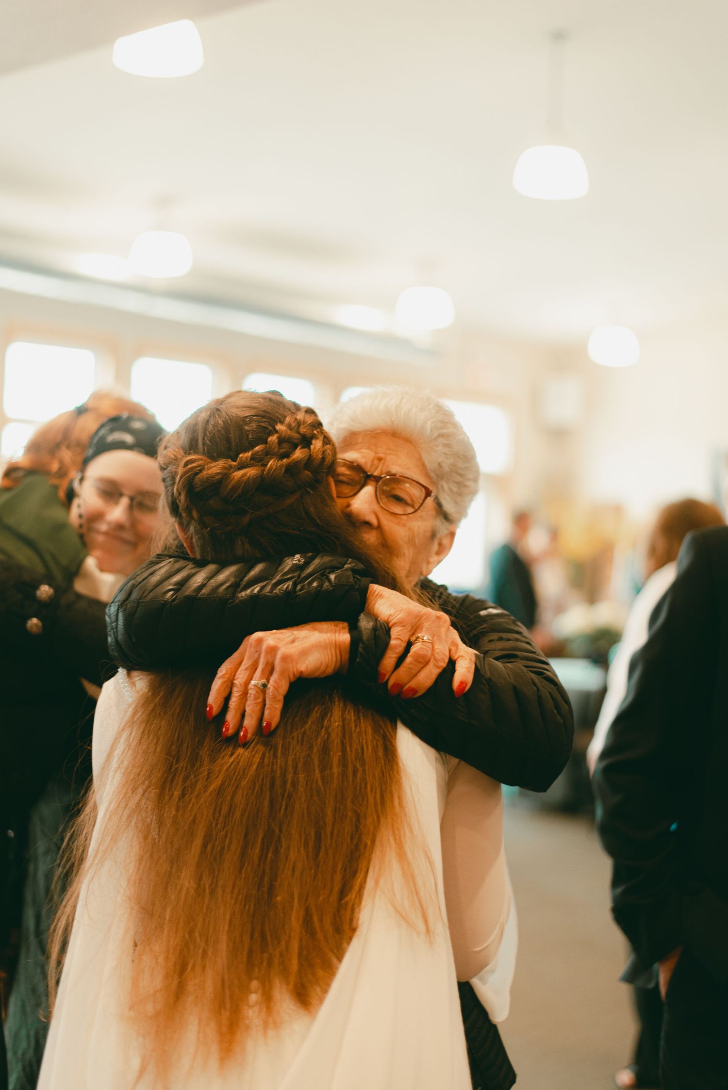 Grandma hug bride and groom at receiving line