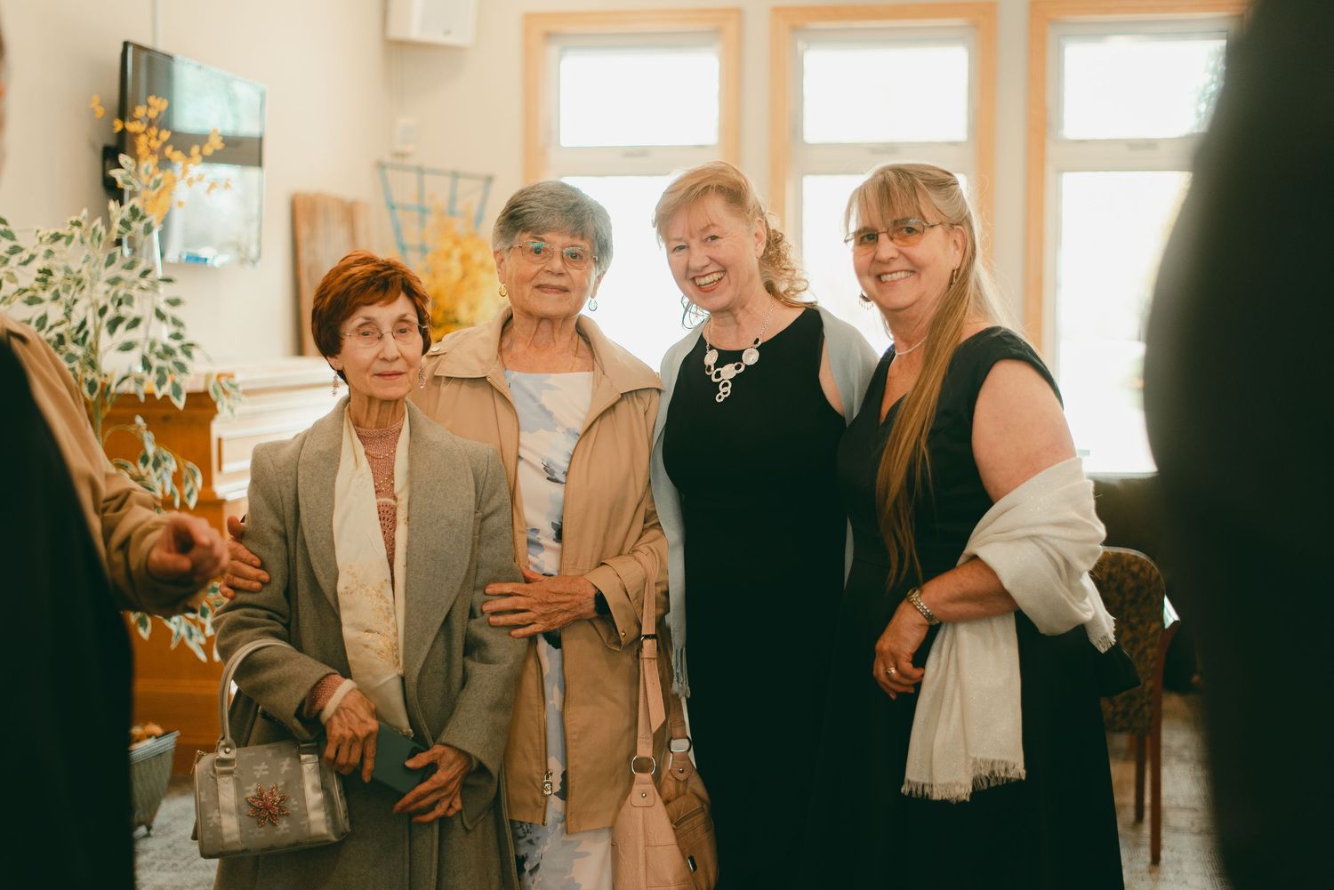 Family and friends pose at lunch time wedding reception
