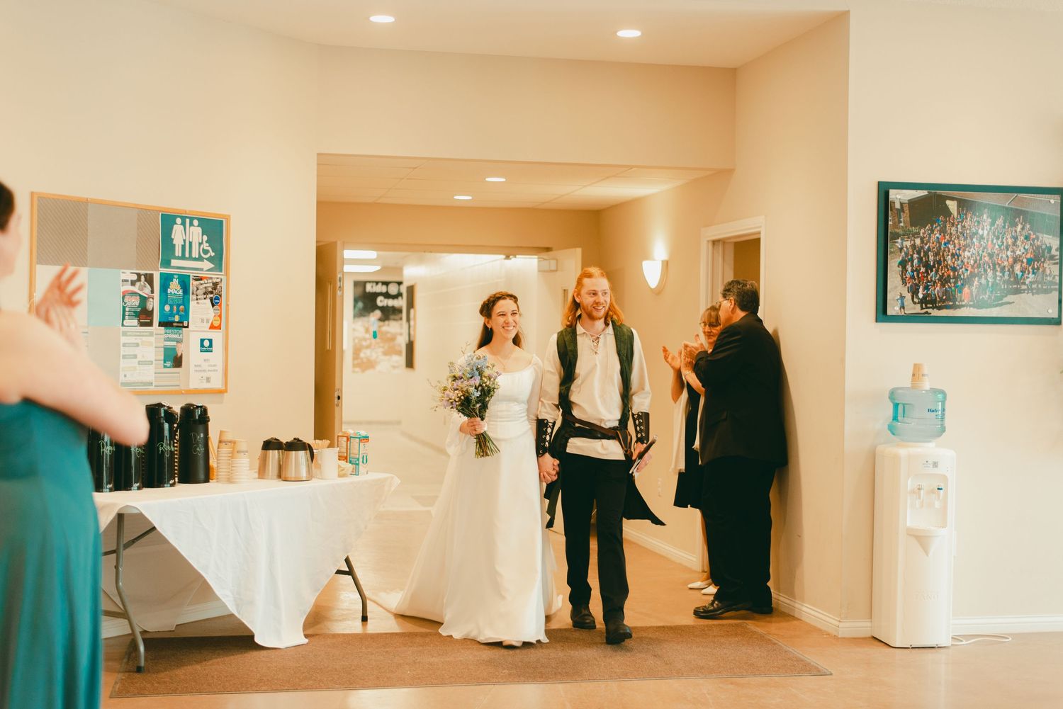 Bride and groom enter lunch time wedding reception