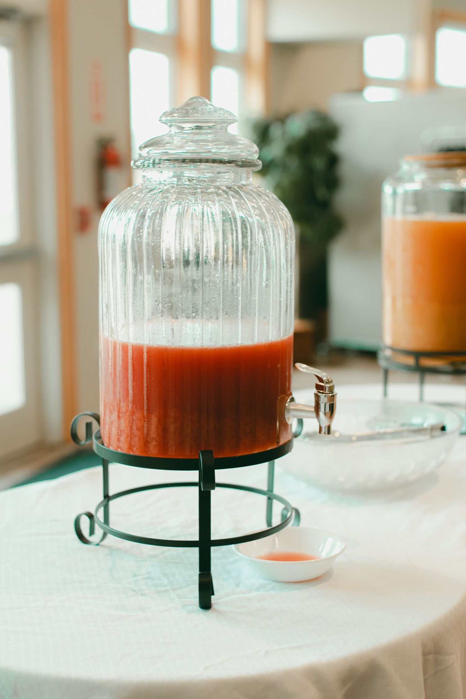 Punch container decor at lunchtime wedding reception