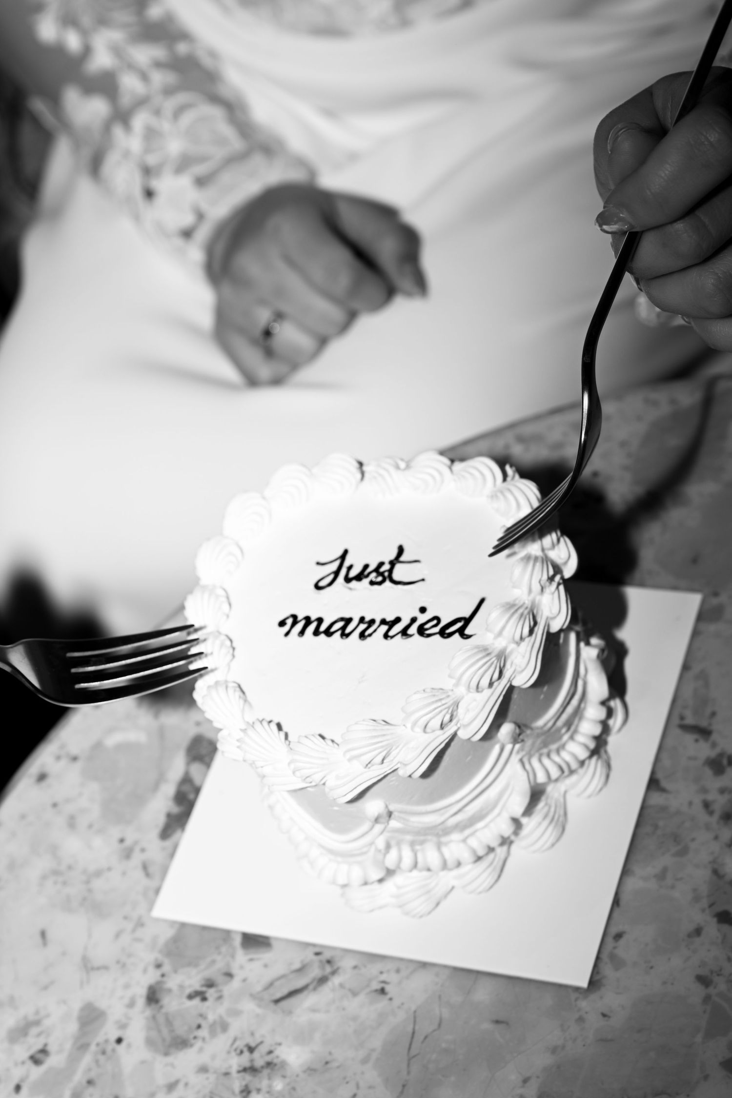 A couple shares a special engagement moment on a scenic cliffside overlooking a misty bay.
