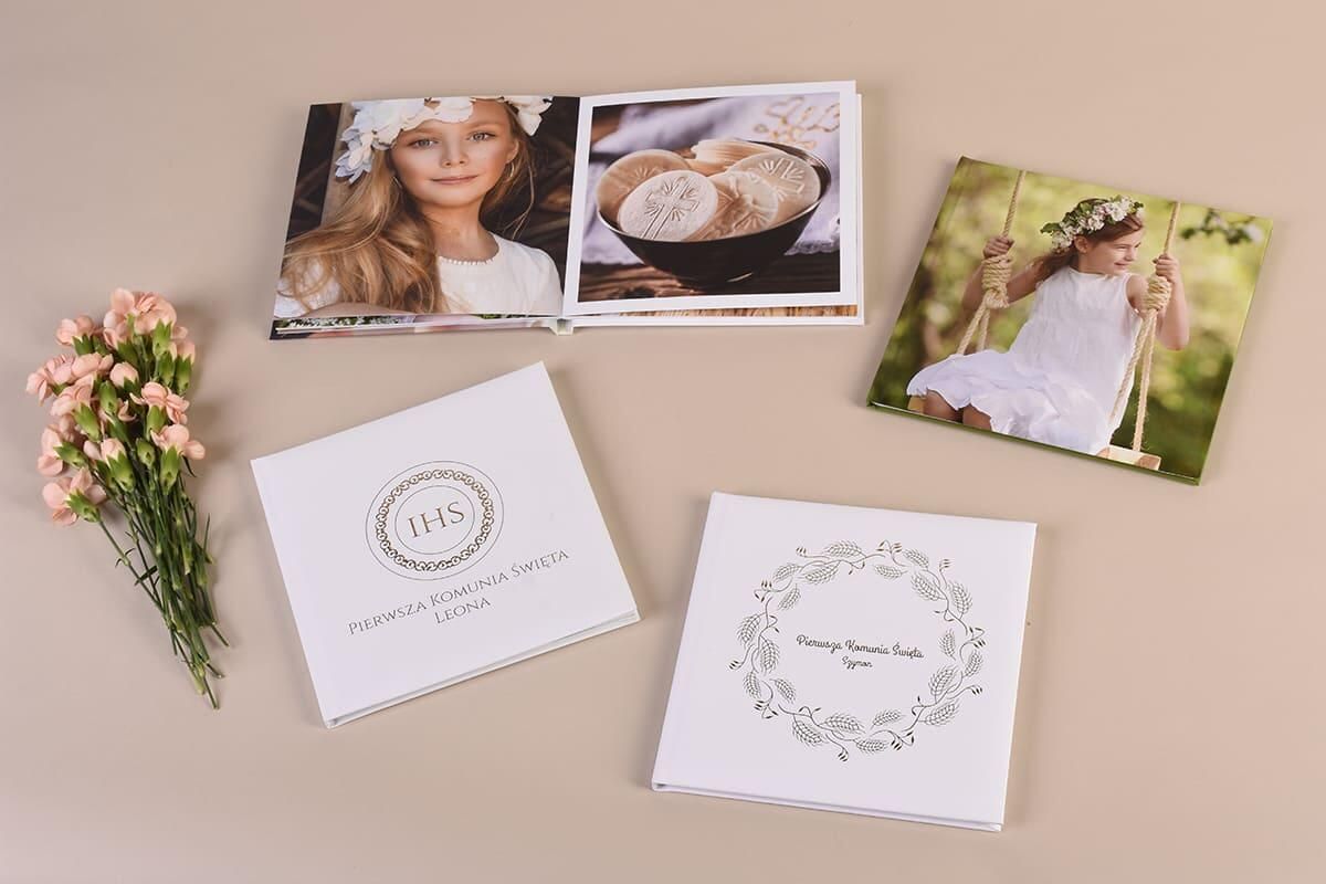 Wedding invitations, thank you cards, and photos arranged on a light beige surface with floral decorations.
