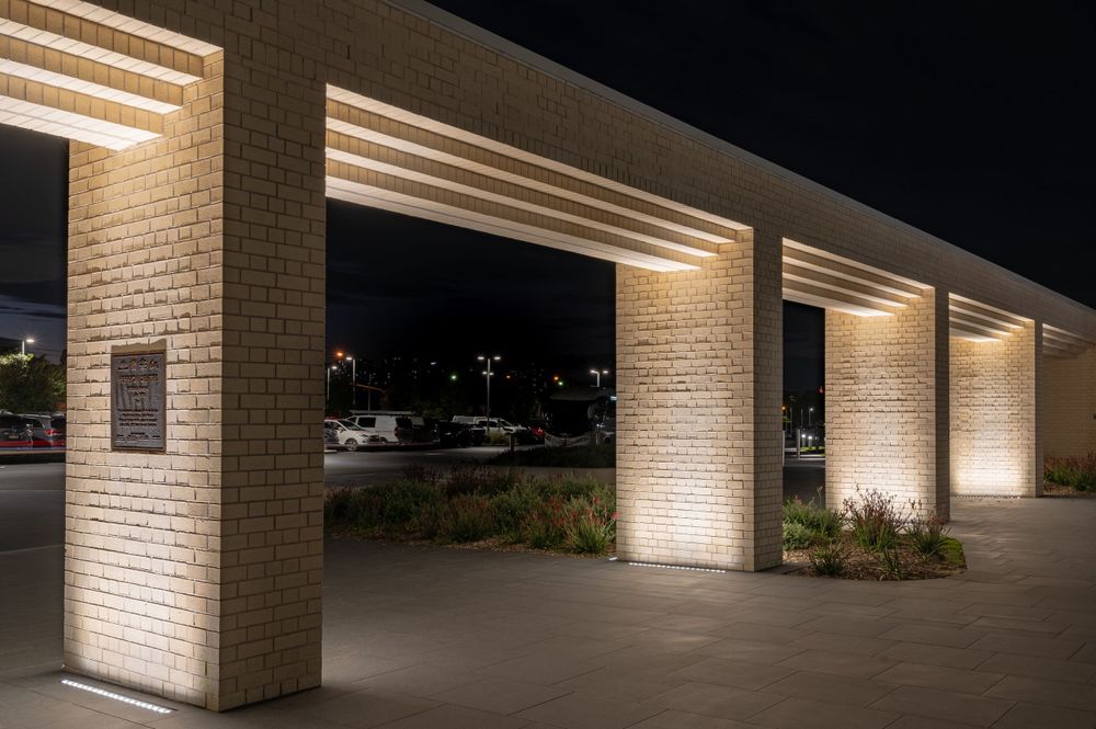 Exterior wall with illuminated columns creating dramatic lighting at night. SIX84 Photography, Architectural Photography, Sydney