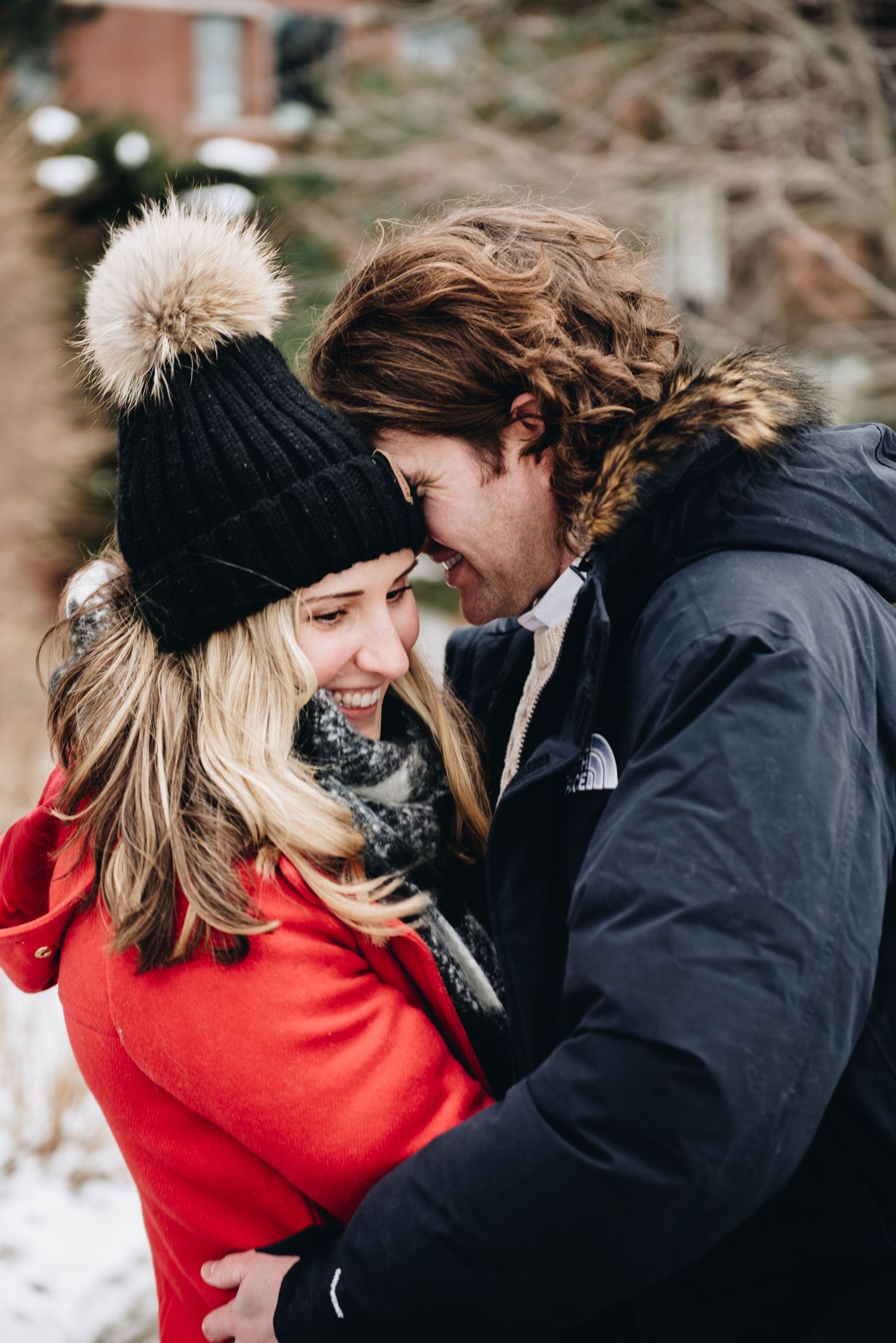 A winter engagement moment shared between two people wearing warm clothing. Massachusetts Engagement Photographer- Affordable