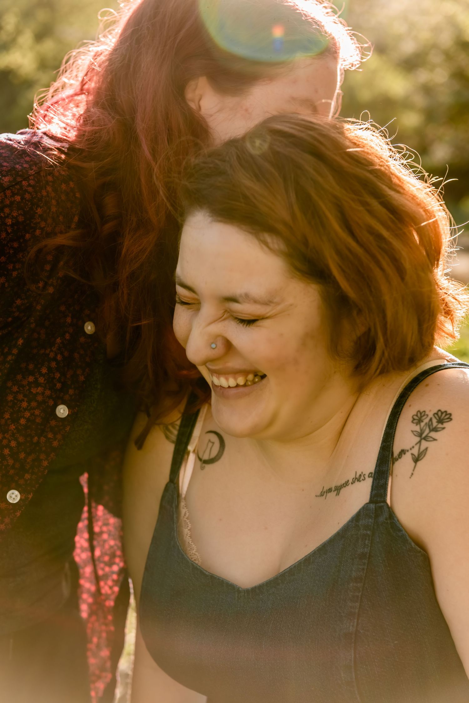 Candid moment of joy and laughter captured in warm sunlight. LGBT LGBTQ+ Friendly photographer
