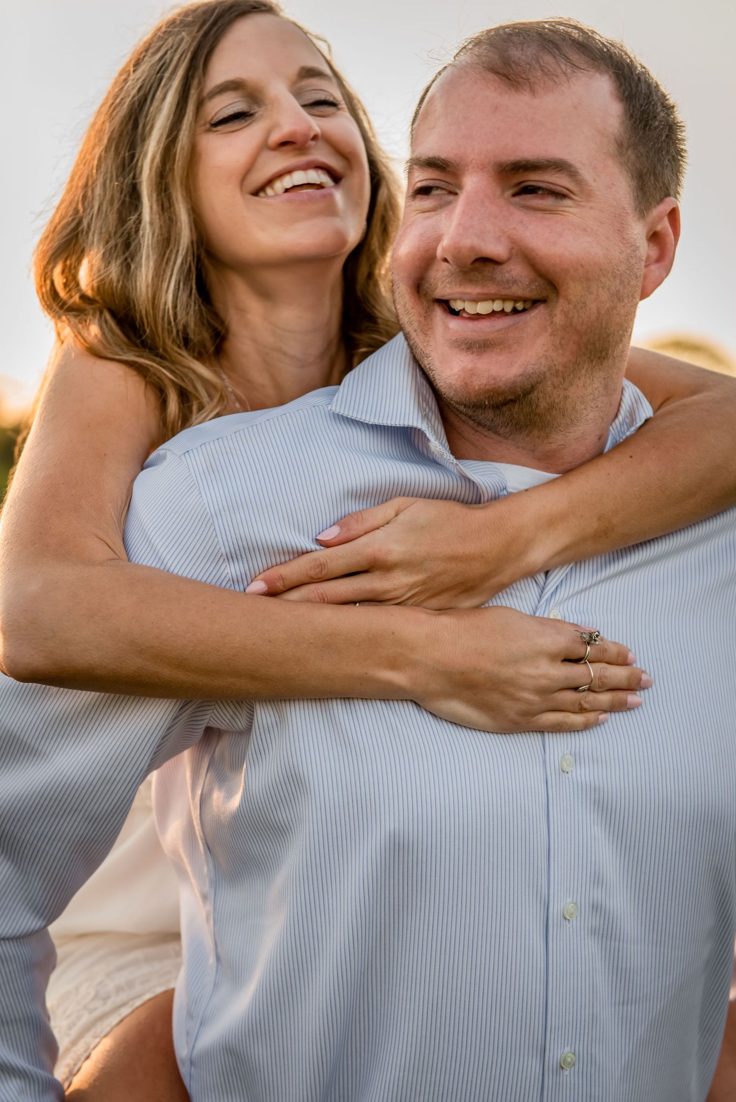 Candid moment of joy and laughter during sunset photoshoot. Massachusetts Engagement Photographer- Affordable