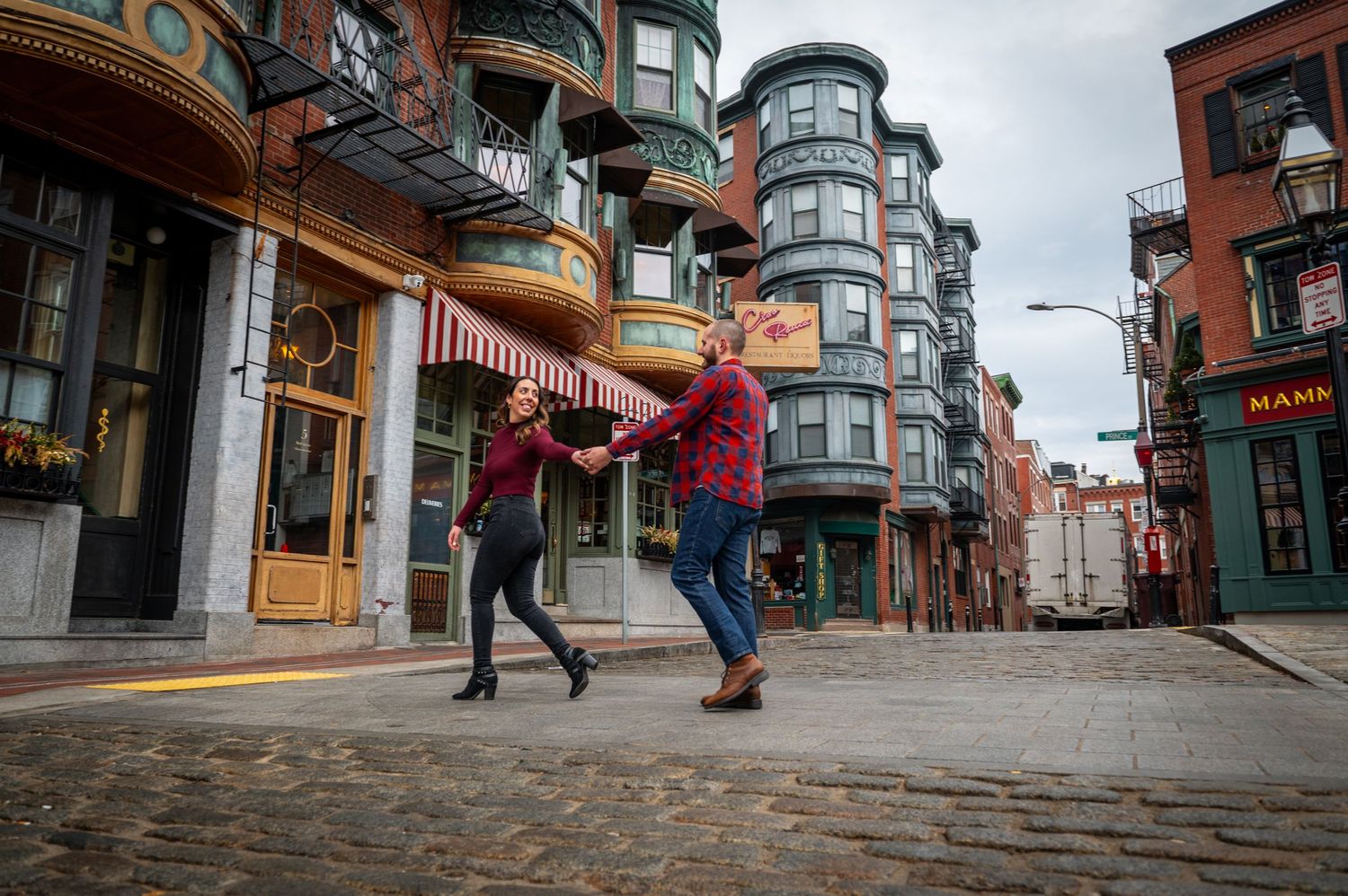 Dancing together on cobblestone streets in Boston's historic district. Boston Engagement Photos- Affordable