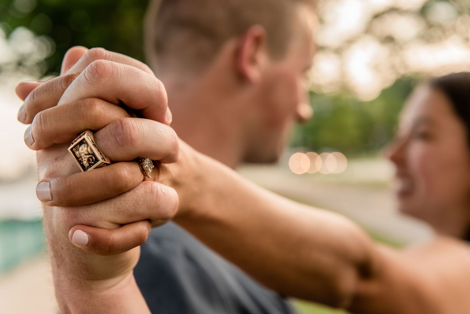 Close up of clasped hands with engagement ring during outdoor photoshoot. Massachusetts Engagement Photographer- Affordable