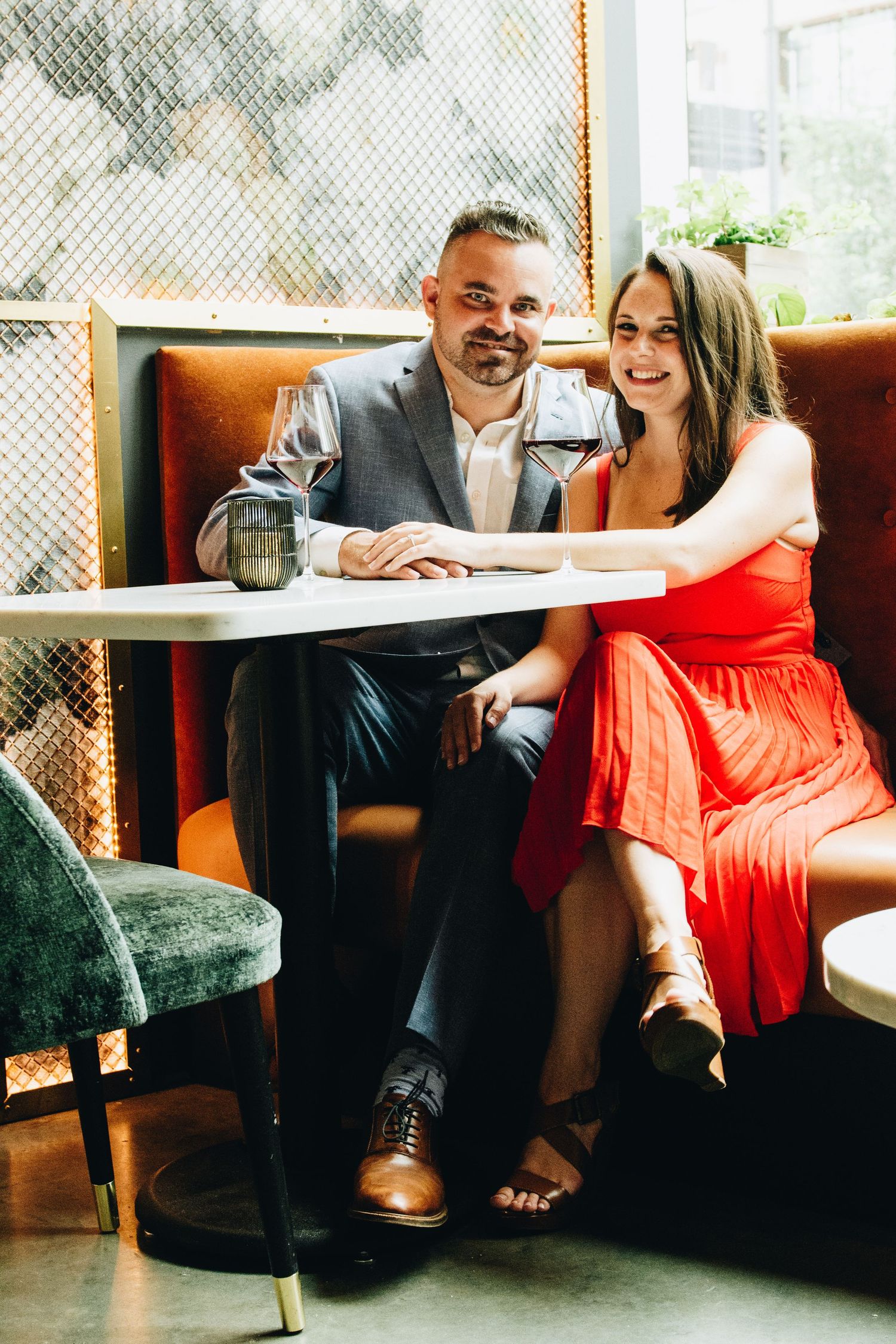 Stylish couple at modern winery booth sharing intimate moment. Massachusetts Engagement Photographer Serving New England