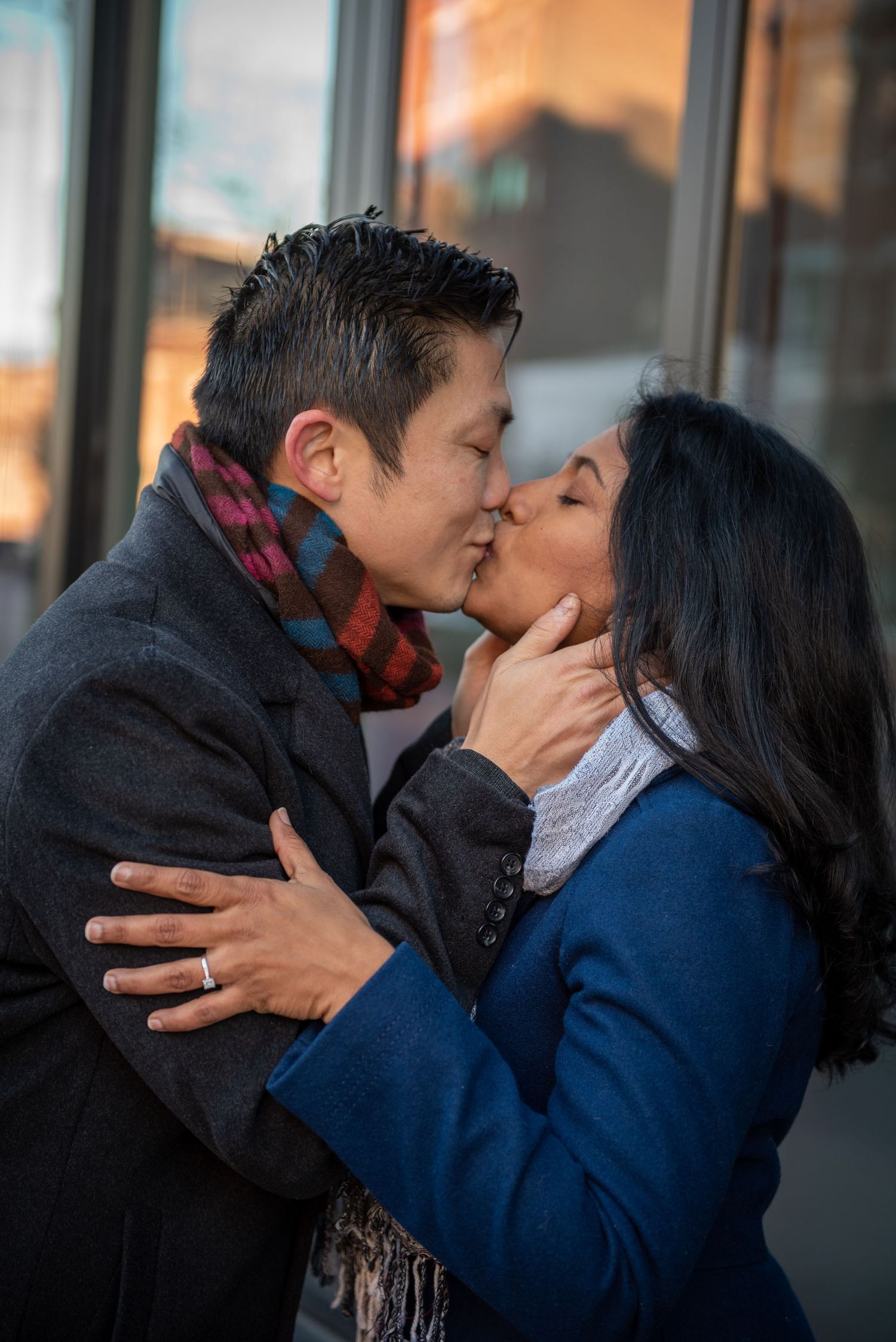 A romantic moment shared between a couple outside on a city street. North End, Boston
